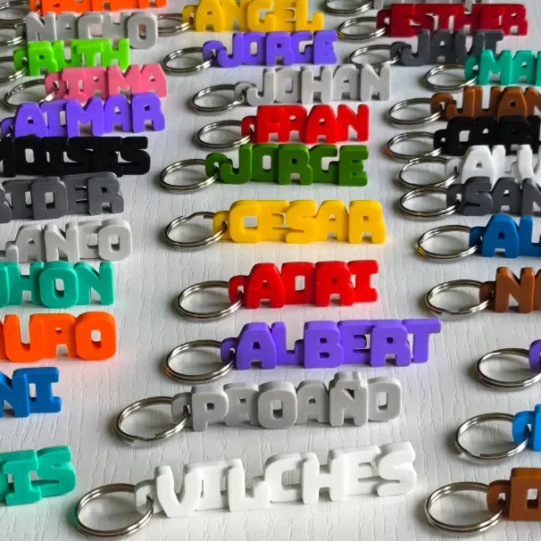 Assorted custom 3D printed name keychains in many colours by Swag Layers