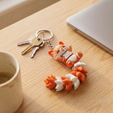 Articulated cat keychain orange – on bag