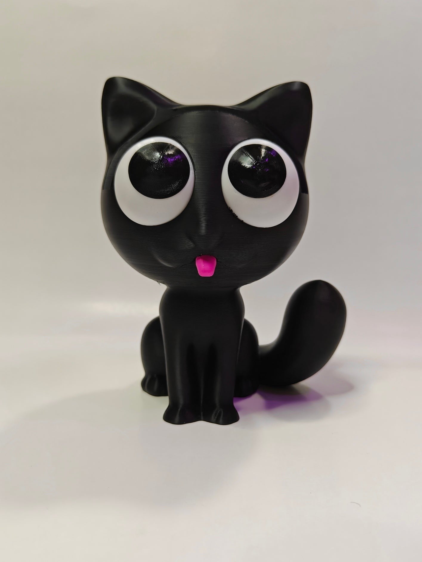 Swag Layers black 3D printed cat glasses holder with large white eyes and a small pink tongue on a white background