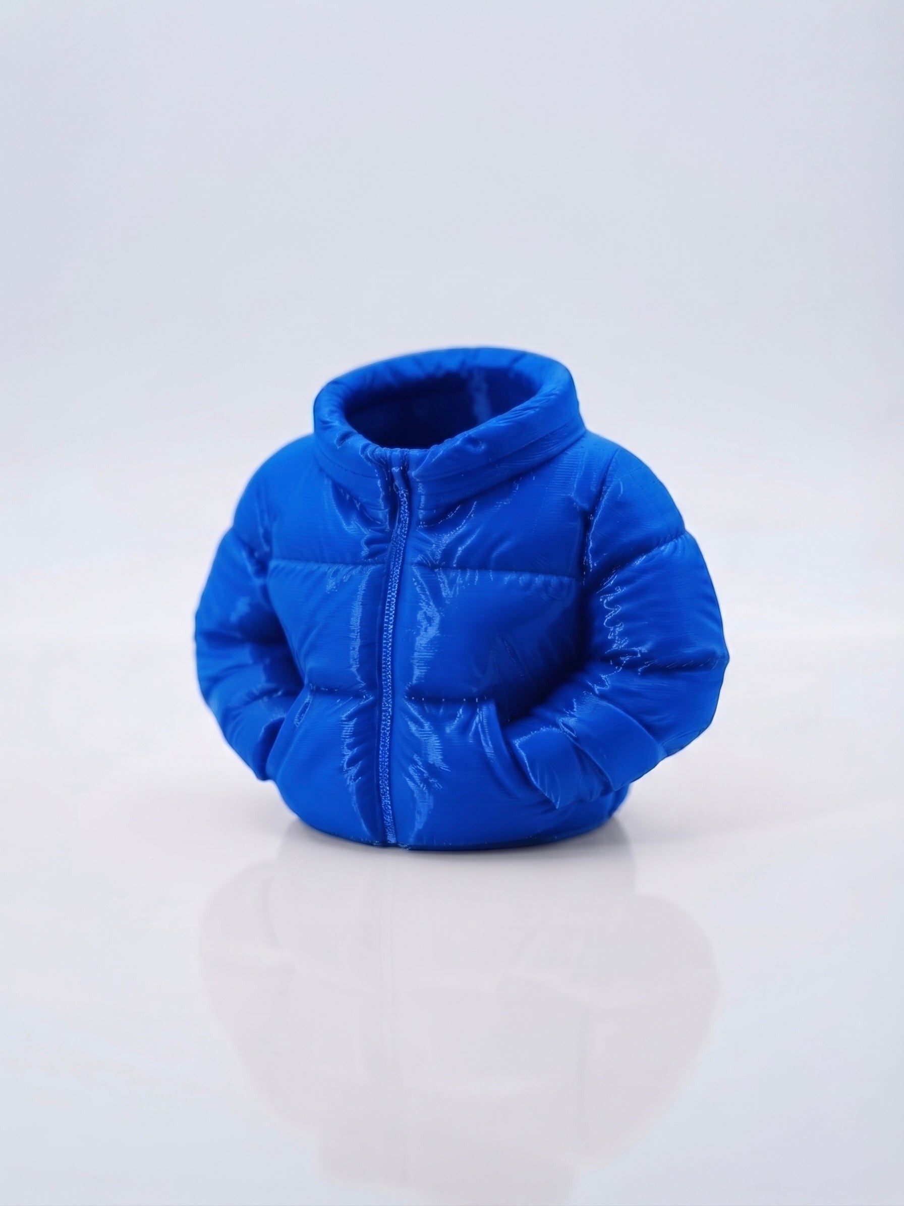 Swag Layers 3D printed blue puffer jacket desk pen holder with realistic quilted texture and high collar design.